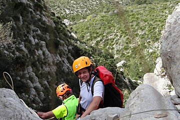 A person wearing a yellow helmet with the word petzl on it